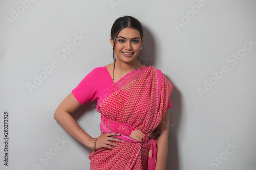 young woman in saree smiling 	
