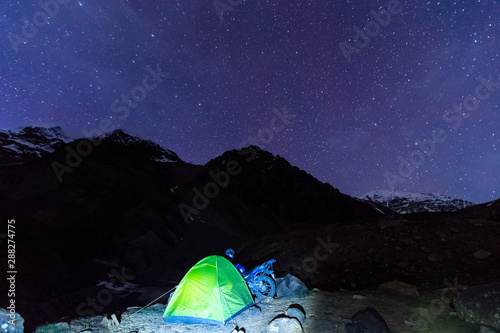camping under milkyway with twinkling stars in the background