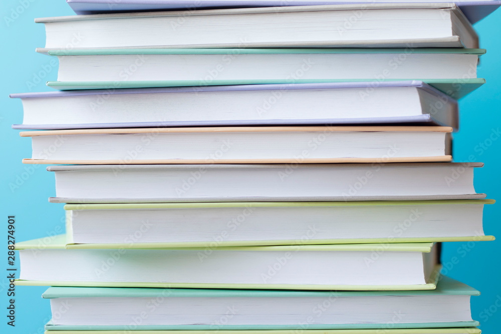 Stack of colorful books on blue background . Education background. Back to school. Stack of colorful books on blue background . Education background. Back to school.