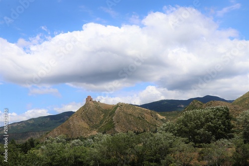 Panoramic view of Caucasus hills  with the Unesco site  Jvari monastery  in the Mtskheta village  near Tbilisi  Georgia.