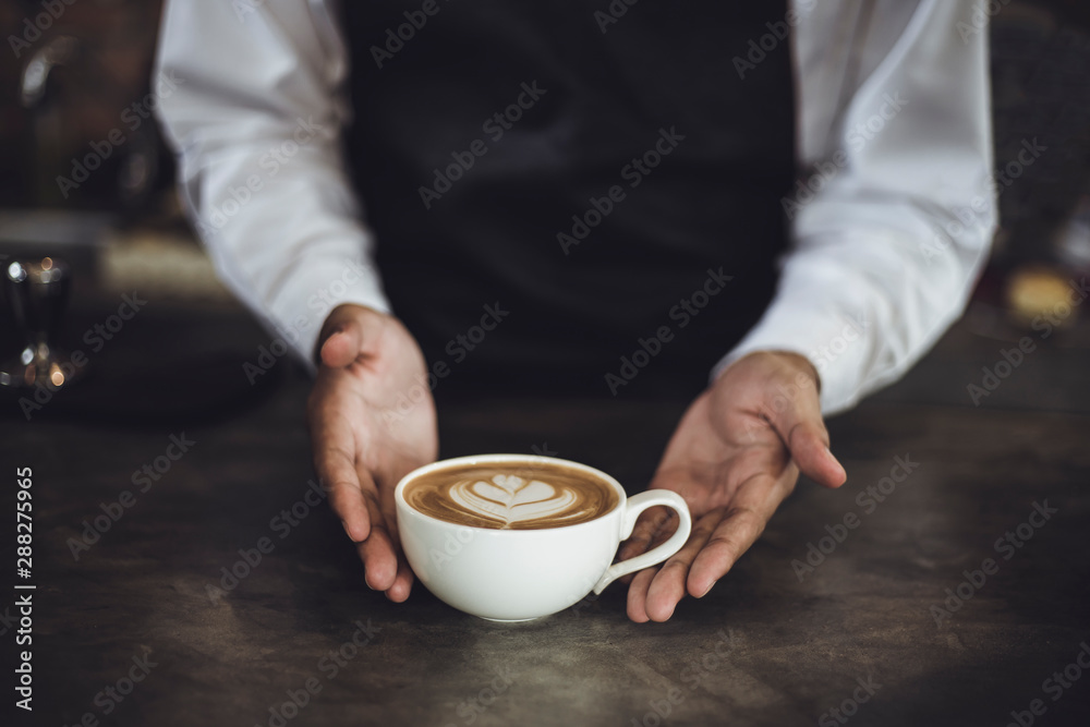 Male Barista preparing coffee for customer in coffee shop. Cafe owner serving a client at the coffee shop. Male Barista preparing coffee for customer in coffee shop. Cafe owner serving a client at the coffee shop.