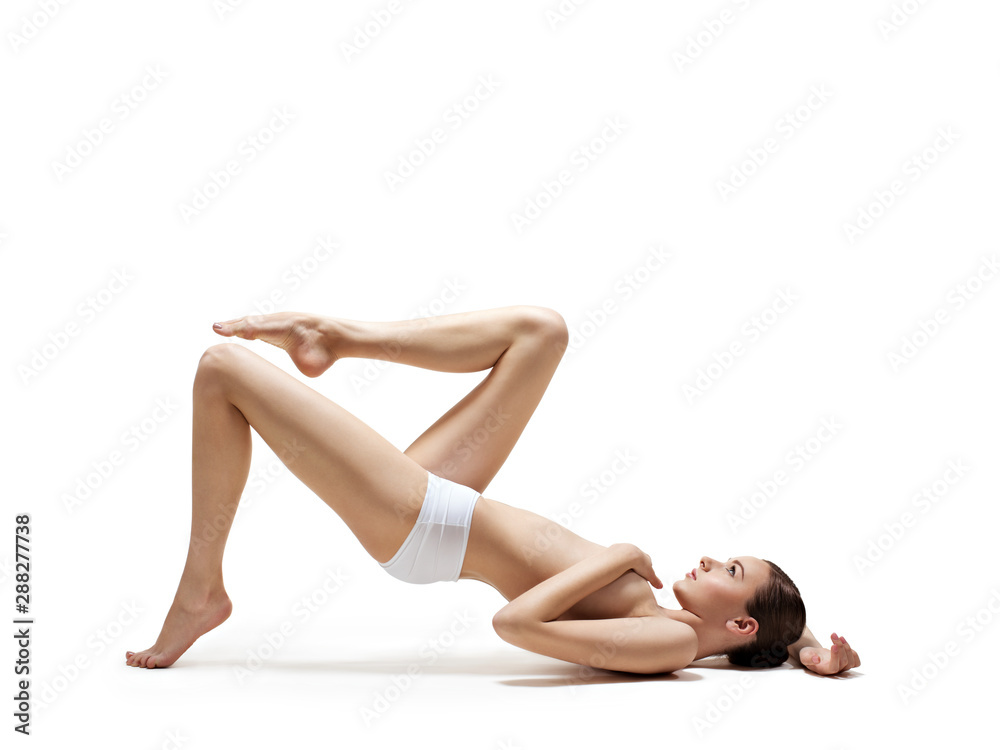 Beautiful woman with perfect body lying on white Beautiful woman with perfect body lying on white