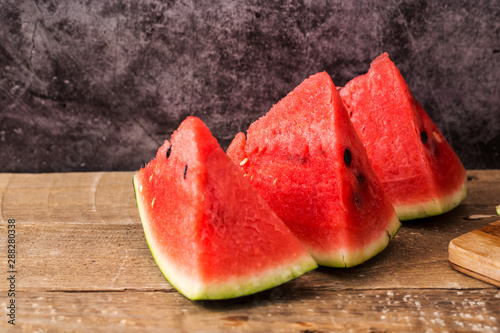 Slices of watermelon on wooden table