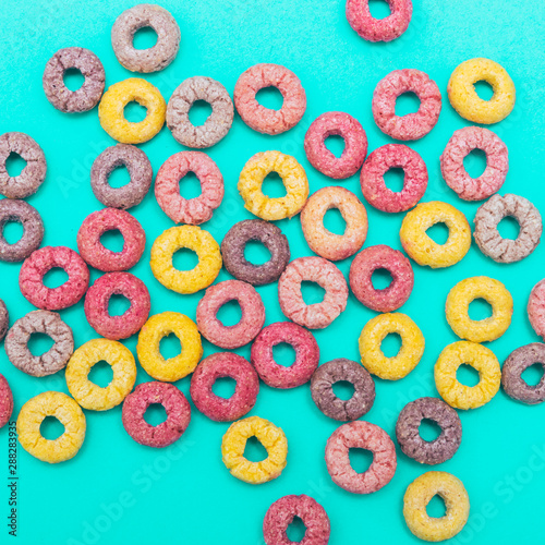 Breakfast cereal rings on turquoise background. Minimalism