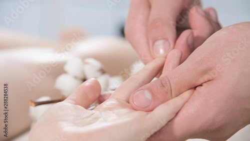 Wallpaper Mural Close-up of a male physiotherapist doing finger and palm massage to a young girl in a massage spa salon. Professional pampering and deep relaxation Torontodigital.ca