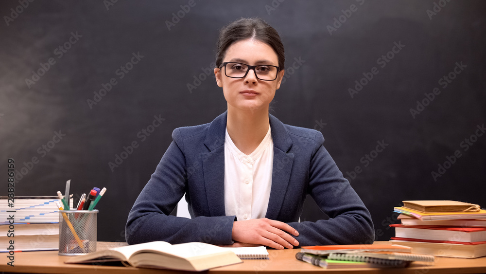 Serious and strict female teacher looking to camera, education reform occupation Serious and strict female teacher looking to camera, education reform occupation