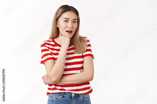 Amazed talkative pretty asian blond female student open mouth gasping surprised listen amused shocking rumor fist faceline chin intrigued hear out juicy gossips, standing white background curious photo