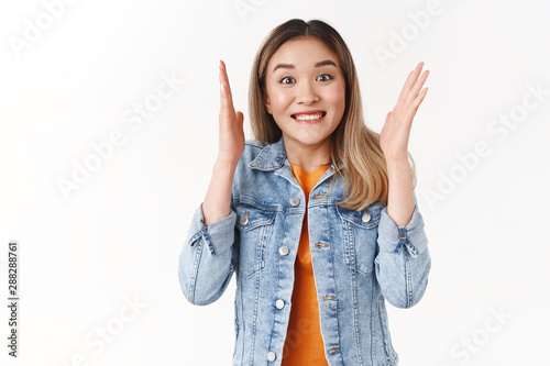 Excited happy triumphing young cute asian girl explaining awesome news shaking hands thrilled smiling broadly look impressed retelling inredible story under great impression, white background photo