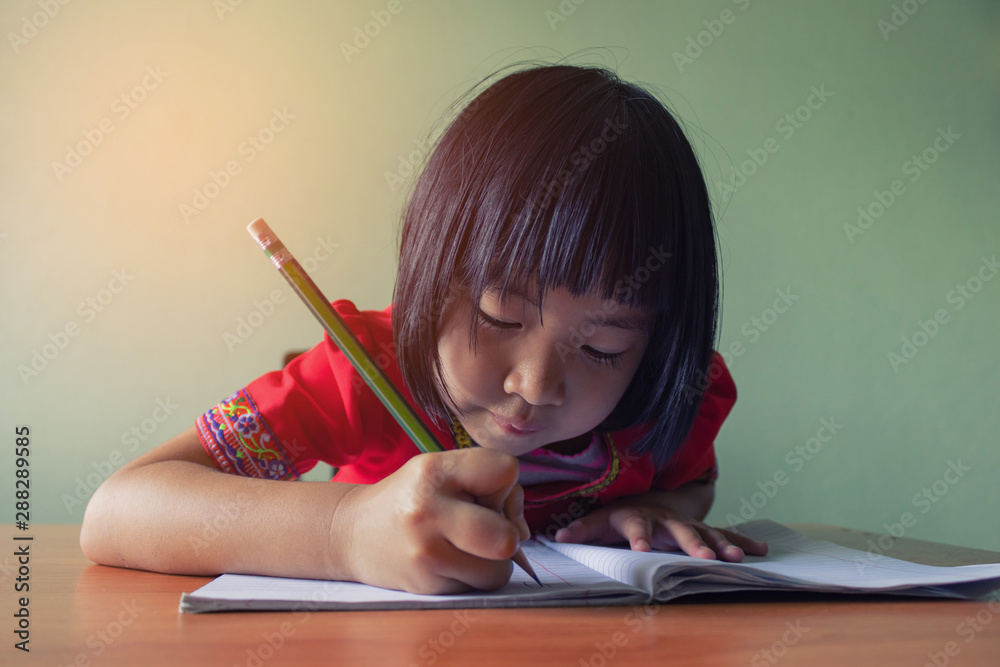 Cute little girl doing homework, reading a book, coloring pages, writing and painting. Children paint. Kids draw. Preschooler with books at home. Cute little girl doing homework, reading a book, coloring pages, writing and painting. Children paint. Kids draw. Preschooler with books at home.