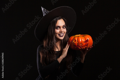 Beautiful caucasian woman in a witch costume for halloween party