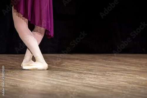 Legs of ballerina in ballet shoes, closeup