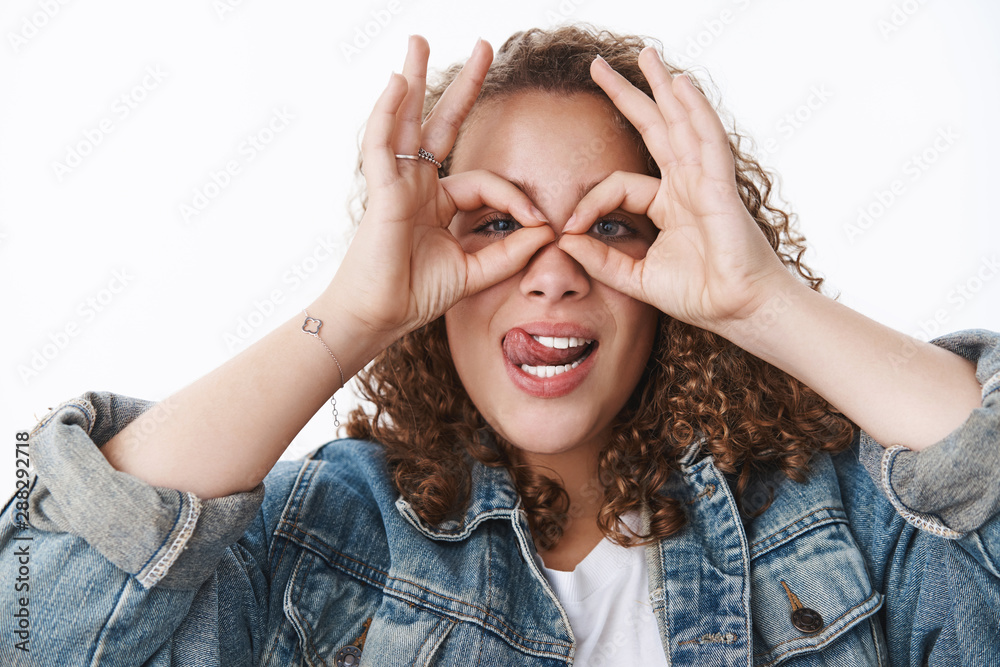 Why so serious. Attractive funny cute silly curly-haired chubby girl fool around making faces stick tongue hold circles eyes mask superhero grimacing mimicking acting childish, white background Why so serious. Attractive funny cute silly curly-haired chubby girl fool around making faces stick tongue hold circles eyes mask superhero grimacing mimicking acting childish, white background