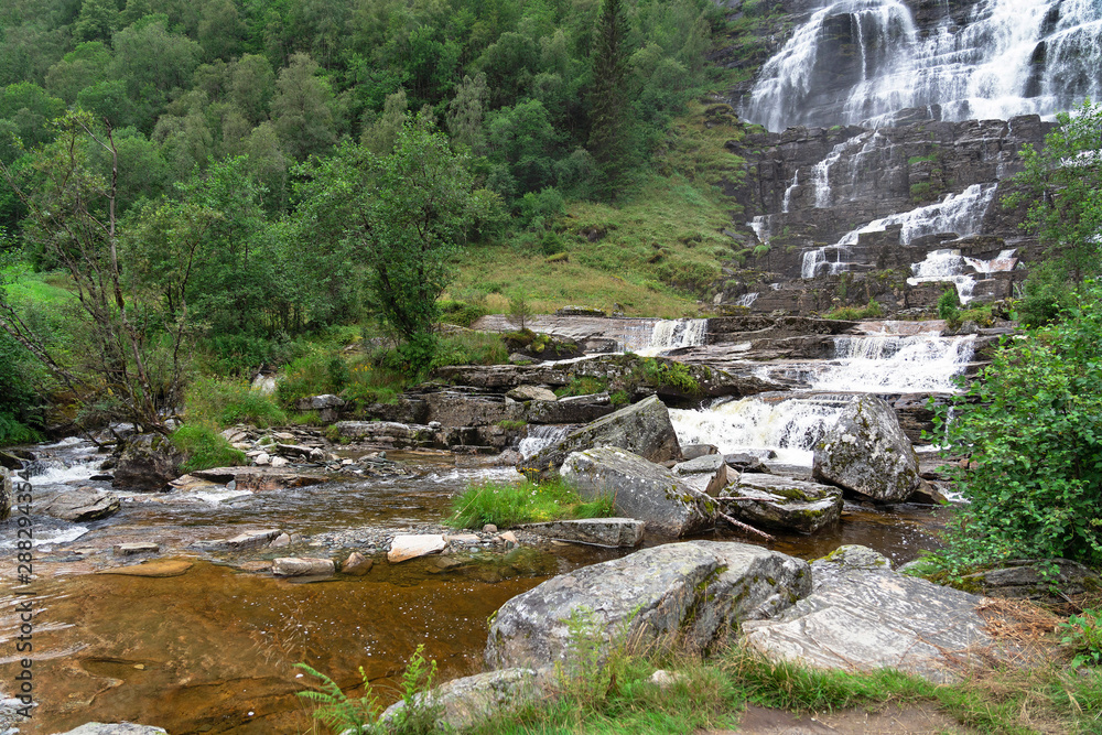 Waterfall landcsape with stones, green forest, Norway Waterfall landcsape with stones, green forest, Norway