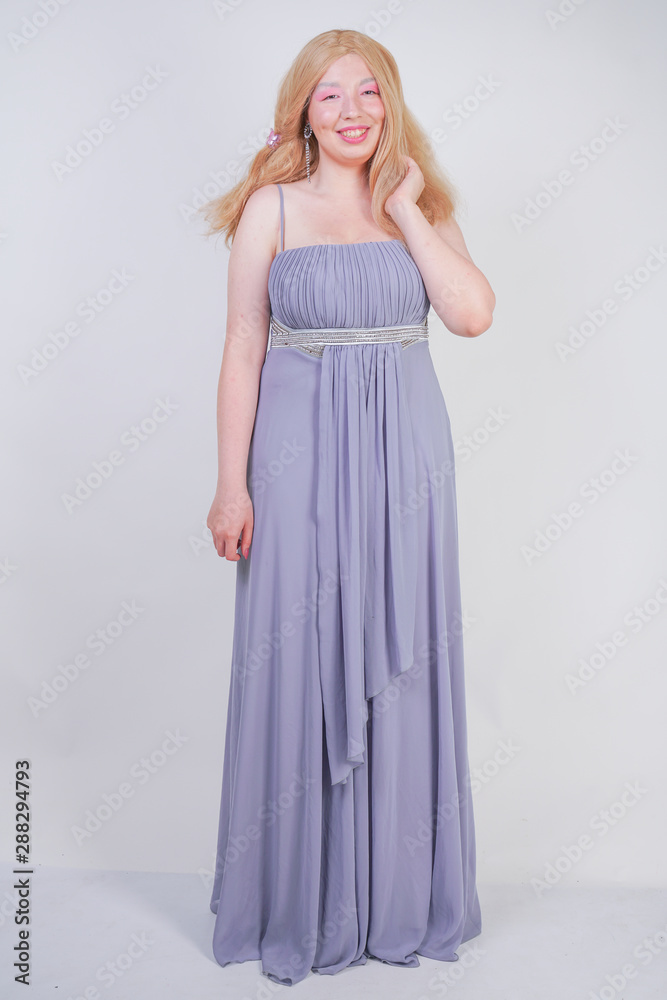 Young mix race happy adult woman in a grey long shiffon evening wear