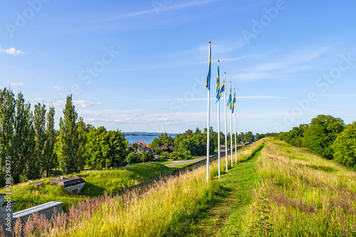 Swedish flags on a rampart and a long path photo