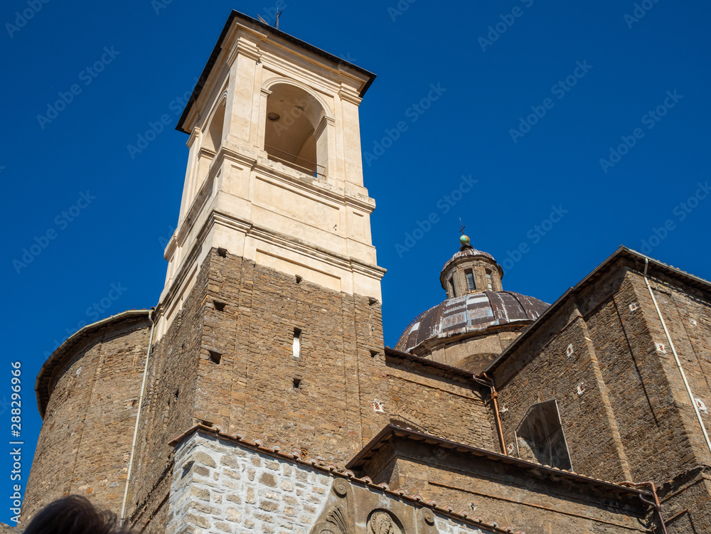 old stone church with a cross on the dome in the old town of Viterbo, Italy