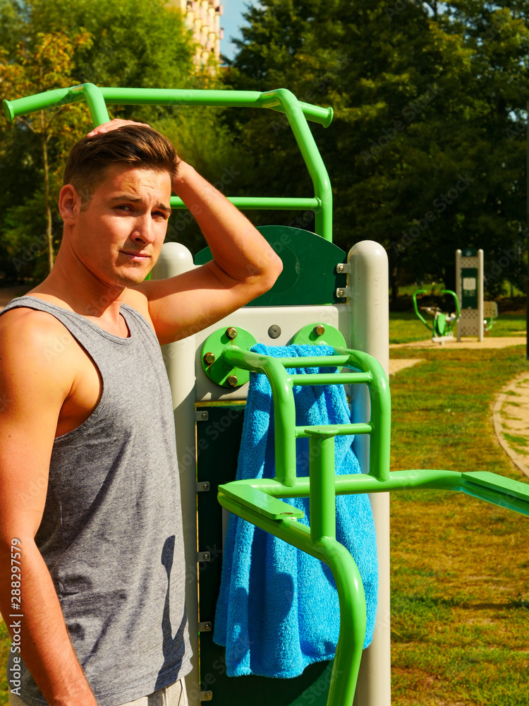 Young man relaxing after outdoor workout - obrazy, fototapety, plakaty 