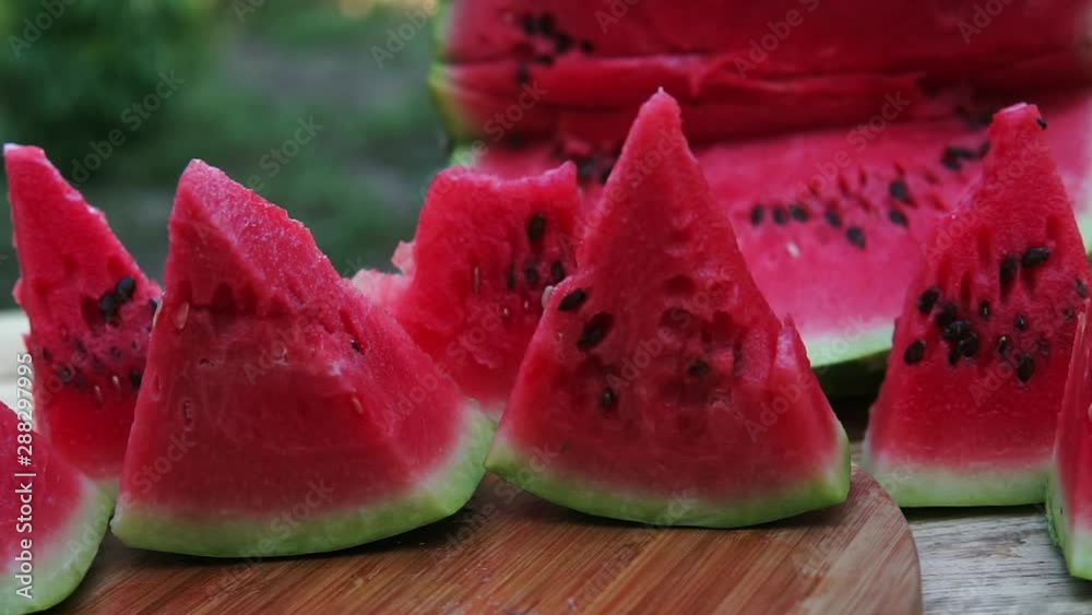 Fresh sliced watermelon wooden background in the garden Fresh sliced watermelon wooden background in the garden