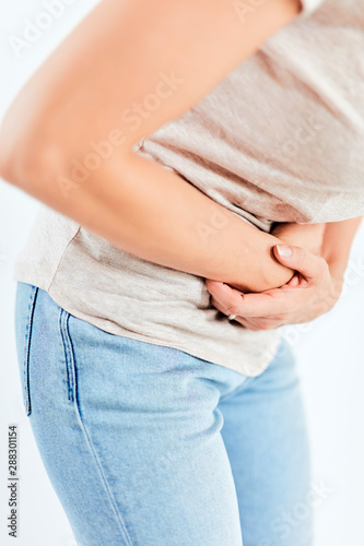 Woman with stomach/ hip issues / problems on the white background.