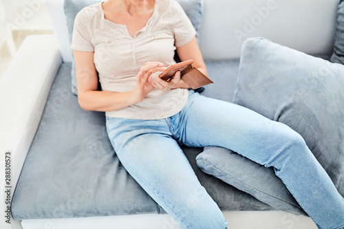 Woman using smart-phone inside the apartment.