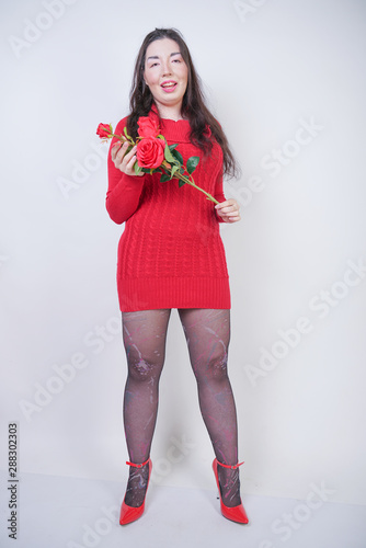 pretty mix raced plus size girl in elegant midi dress on white studio background with rose photo