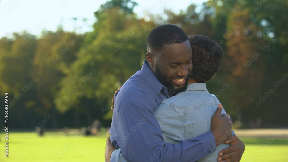 Uncle hugging nephew smiling each other, relations connection, family love