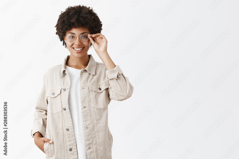 She can answer any question. Smart and creative female journalist in beige shirt and glasses, touching rim of eyewear, smiling, holding hand in pocket, self-assured and satisfied with great result She can answer any question. Smart and creative female journalist in beige shirt and glasses, touching rim of eyewear, smiling, holding hand in pocket, self-assured and satisfied with great result