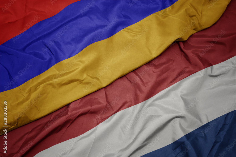 waving colorful flag of netherlands and national flag of armenia. waving colorful flag of netherlands and national flag of armenia.
