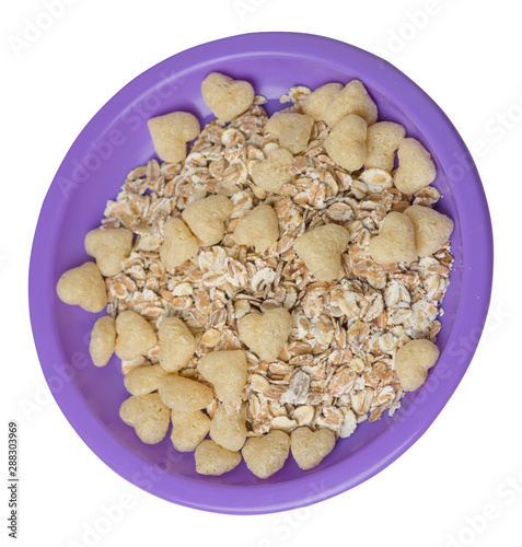 healthy breakfast on a plate isolated on white background.muesli with cornflakes, raisins, dates, pears and pineapple dried cashew nuts.breakfast top view photo