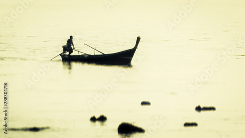 Asian fisherman returning in the evening