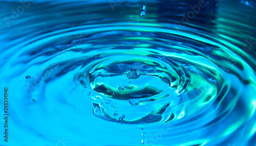 Ripples in color blue water background