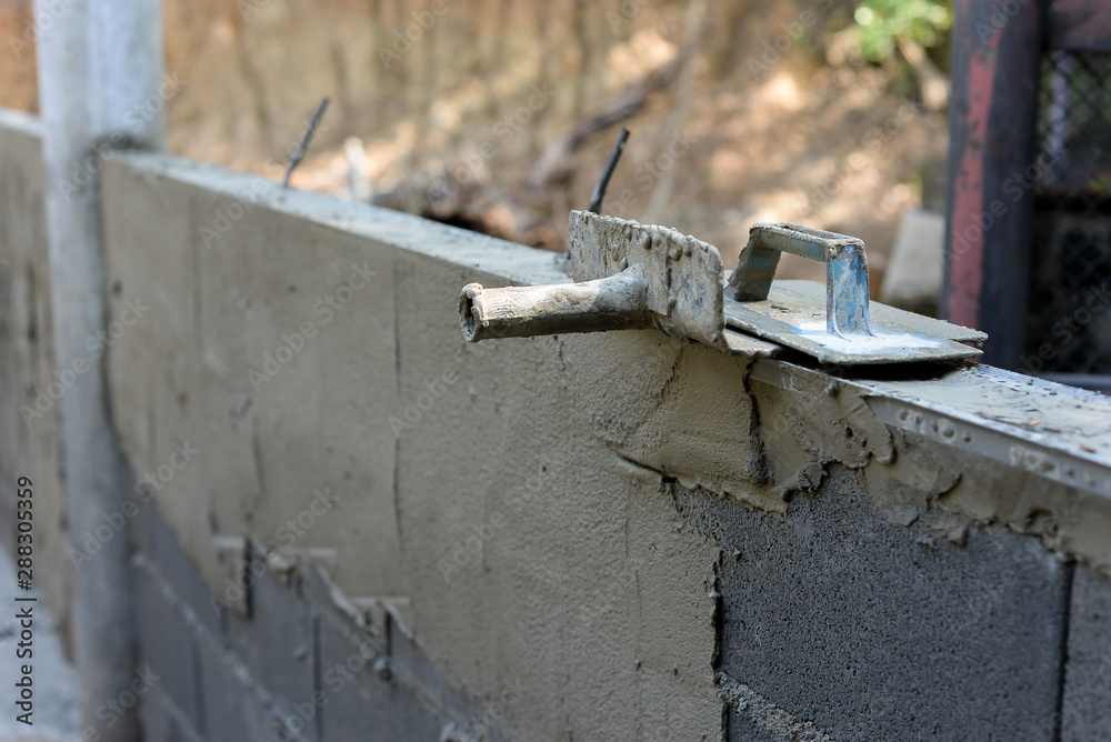 Spread cement on bricks