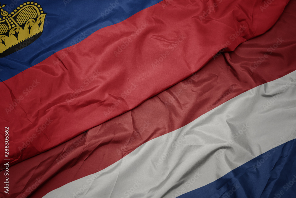 waving colorful flag of netherlands and national flag of liechtenstein.