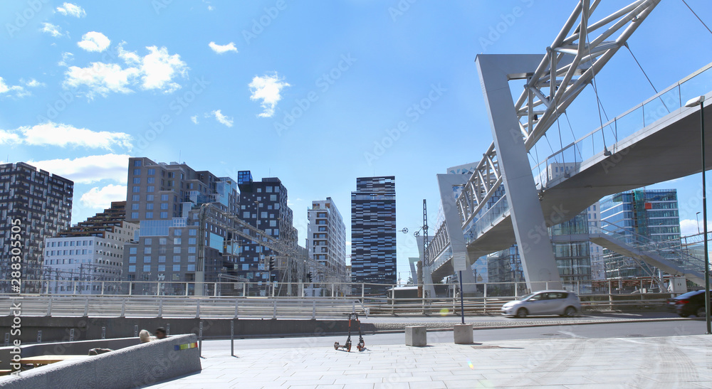 Modern business architecture in the center of Oslo.  Akrobaten pedestrian bridge in Bjorvika district.  Bridge across the tracks of Oslo central station. 