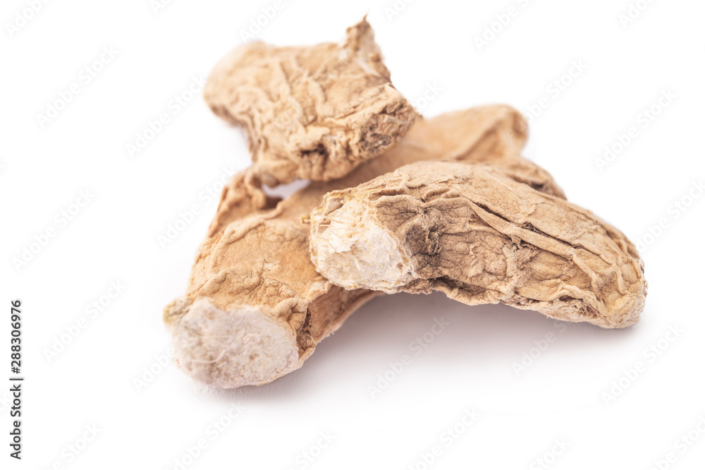 DRY GINGER MACRO SHOT ON WHITE BACKGROUND DRY GINGER MACRO SHOT ON WHITE BACKGROUND