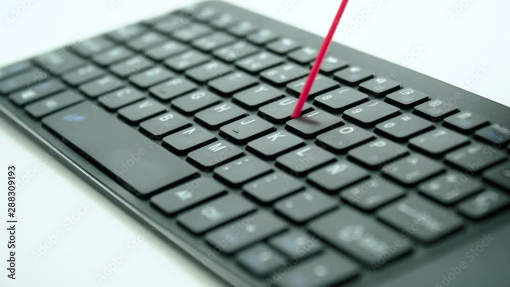 Dusting black keyboard with compressed air, Macro Close Up on White Background Dusting black keyboard with compressed air, Macro Close Up on White Background