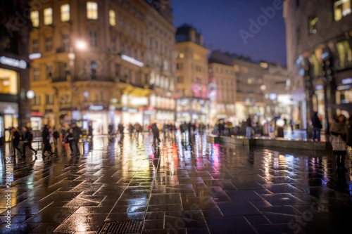 crowd of people walking on night streets in the city © babaroga