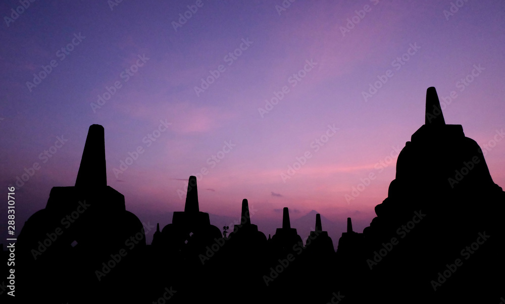 Natural amazing sunrise view at Borobudur Buddhist temple, great religious architecture in Magelang, Central Java, Indonesia.