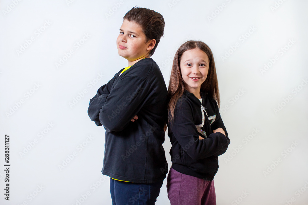 a little girl and a boy stand shoulder to shoulder a little girl and a boy stand shoulder to shoulder