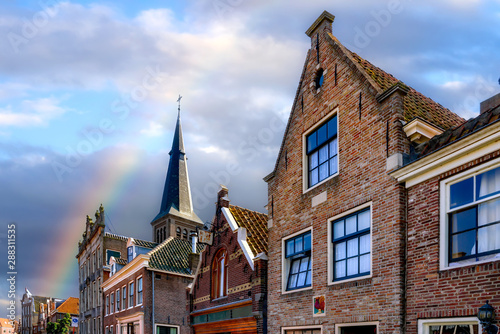 Beautyful facades and cloudy sky with rainbow in Monnickendam, Netherlands