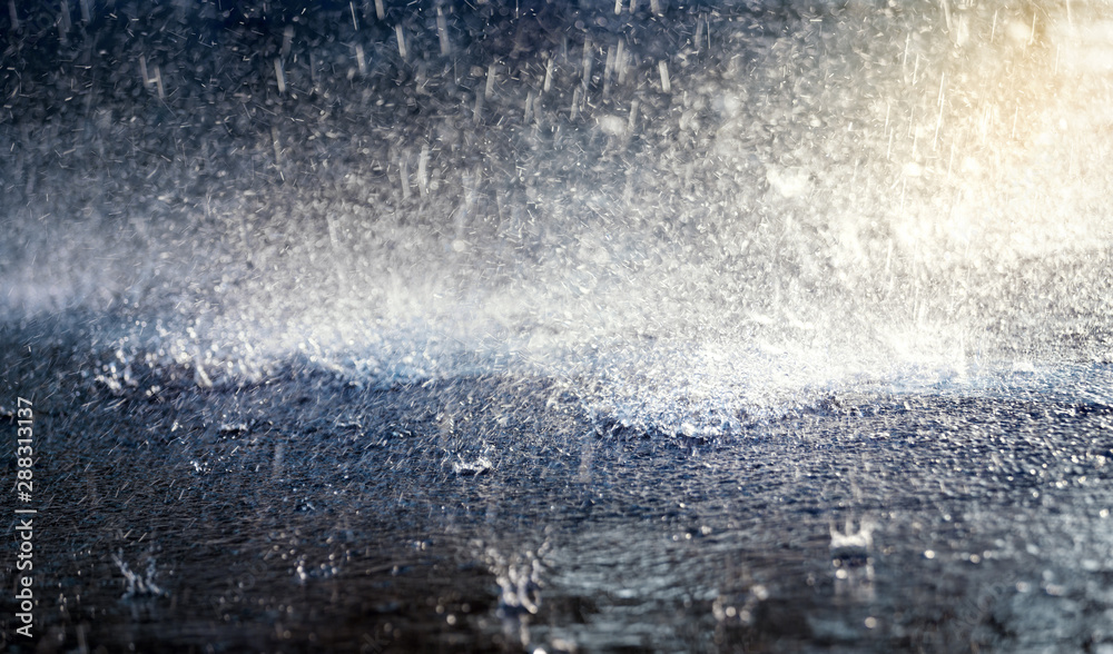 Fotografie Heavy rain drops on asphalt road.Selective focus.