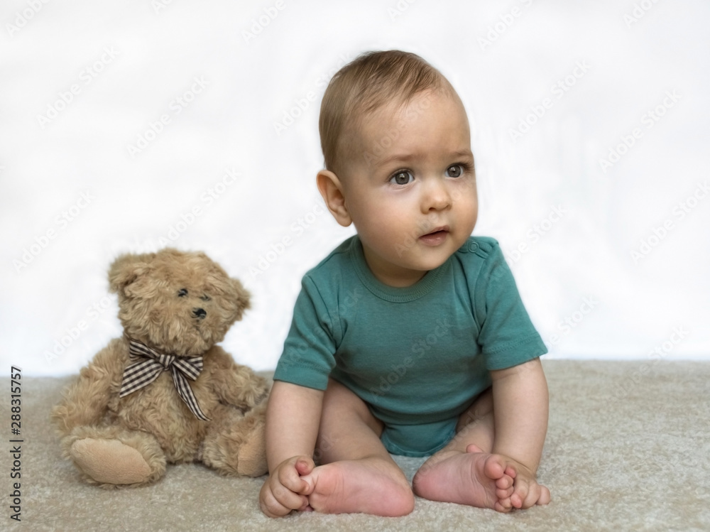 Sweet little baby boy with teddy bear on white background Sweet little baby boy with teddy bear on white background
