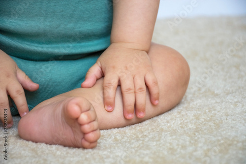Little baby hand and foot close up detail, selective focus.