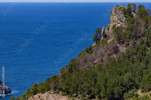 Scenic view at landscape of Serra de Tramuntana on island Mallorca, Spain on a sunny day with rocks and mediterranean sea in background