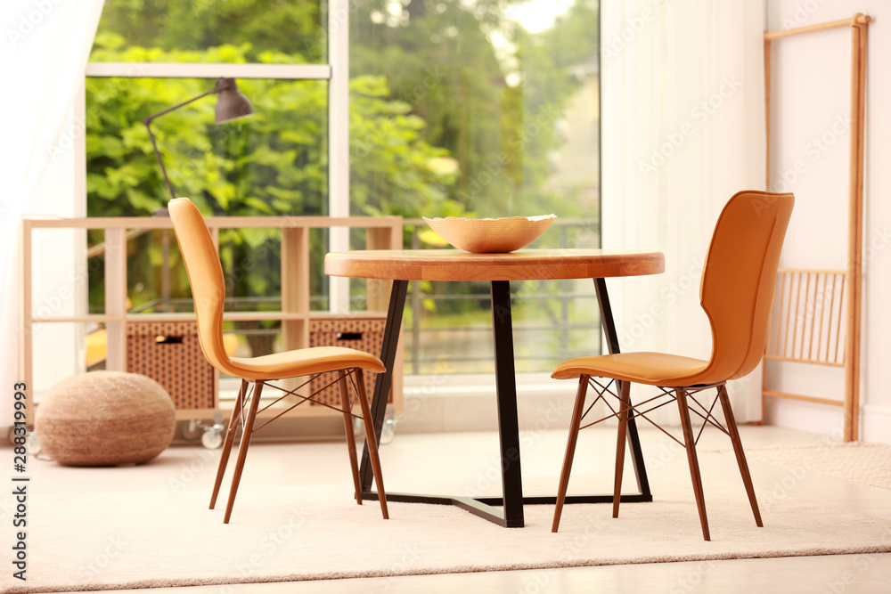 Fototapeta premium Modern dining room interior with table and chairs