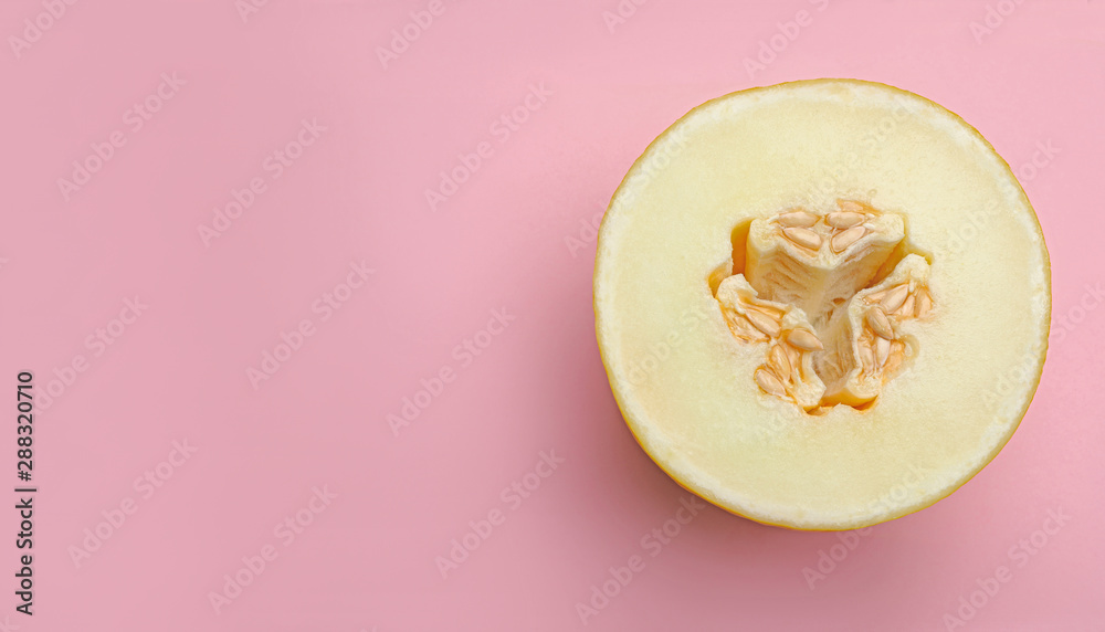 Half of ripe tasty melon on pink background, top view. Space for text