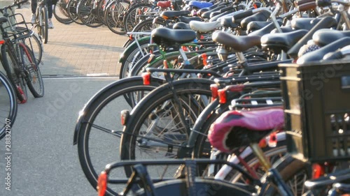 Wallpaper Mural Amsterdam, Netherlands - April 21, 2019: Parking for bicycles. Many different bicycles parked on the street in special parking lots. The problem of bicycle overload in the country Torontodigital.ca