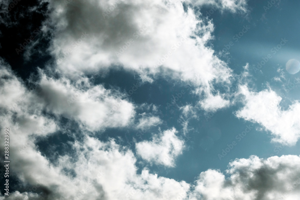 Obraz premium White fluffy clouds on a dark background