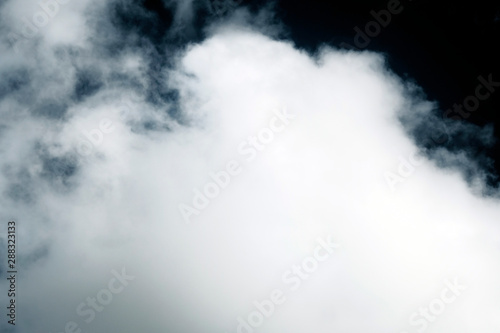 White fluffy clouds on a dark background