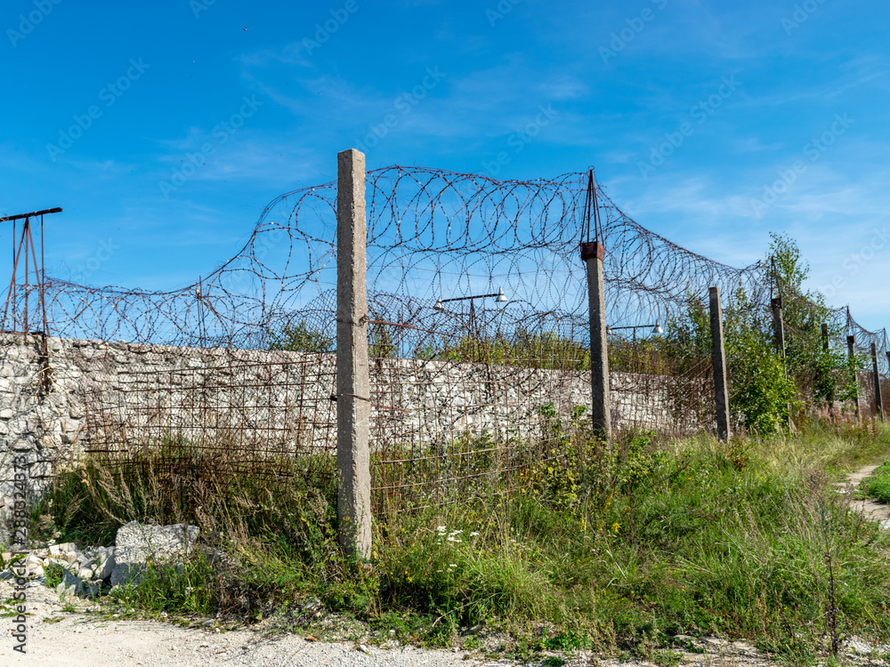 Fragment of barbed wire mounted above prison fence, Rummu quarry, Estonia